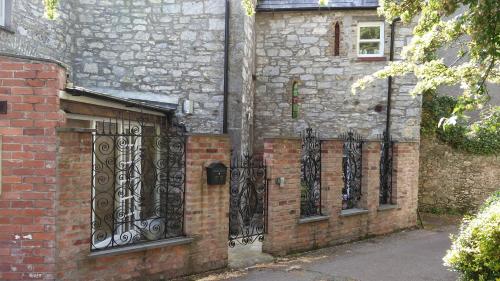 a brick building with wrought iron gates on it at Historic Hideaway in Cork City Centre in Cork