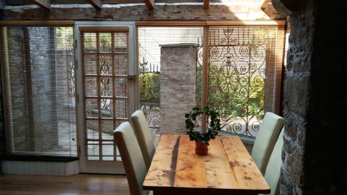 a wooden table with chairs and a potted plant on it at Historic Hideaway in Cork City Centre in Cork