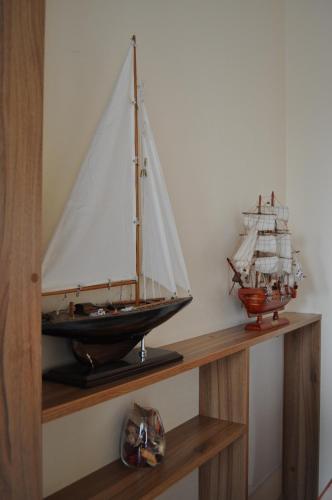 a wooden model of a ship on a shelf at Molo Užeiga Inn in Klaipėda