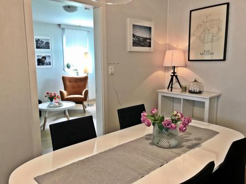 a dining room with a table with flowers on it at Apartment 19 in Selfoss
