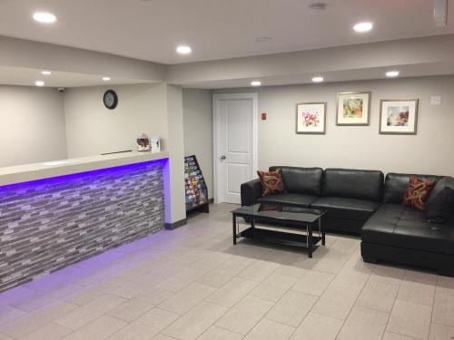 a living room with a couch and a fireplace at Knights Inn Kamloops in Kamloops