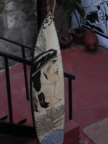 a surfboard with a picture of a woman on it at Hostal Tunquelen in Valparaíso