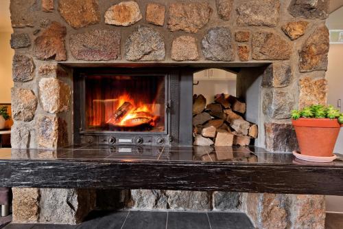 a fireplace with a fire burning inside of it at Pure Chalet Thredbo in Thredbo