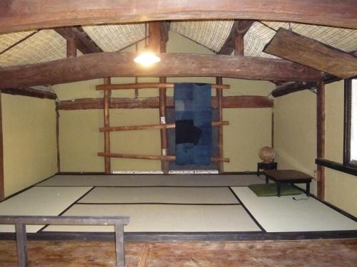 a room with a stage with a wooden ceiling at Kitamineyama Gotsuan in Kimino