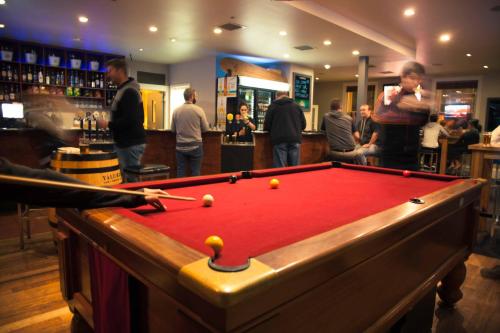 a pool table with balls on it in a bar at Sporties Hotel in Launceston