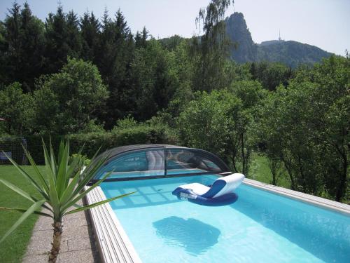 a swimming pool with a car on top of it at Pension Nocksteinblick in Salzburg