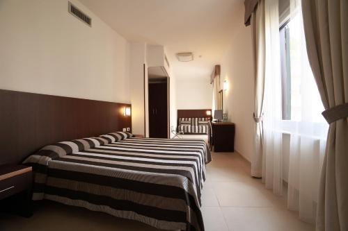 a row of beds in a hotel room at Hotel Margherita in Monterosso al Mare