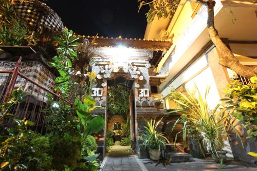 an indoor garden with plants in a building at Surya Inn in Kuta