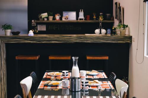 a table with plates of food on it in a restaurant at So Art Guesthouse in Sanyi