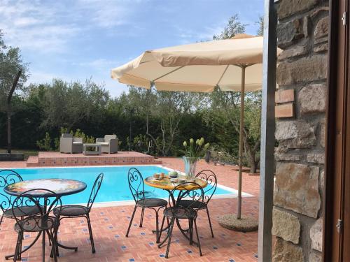 a patio with a table and chairs and an umbrella at Casa Vacanze Il Cenito in Castellabate