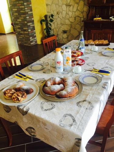 a table with plates of pastries on top of it at San Michele in Foglianise