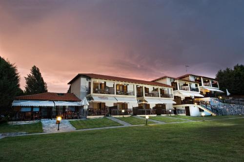 a building with a lawn in front of it at Panorama Studios in Ierissos