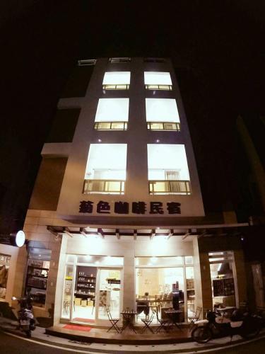a tall building with lit windows at night at G.S Cafe in Magong
