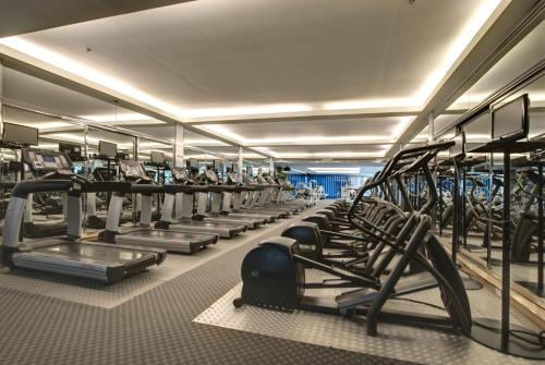 a large gym with rows of tread machines at Pathumwan Princess Hotel - SHA Extra Plus Certified in Bangkok
