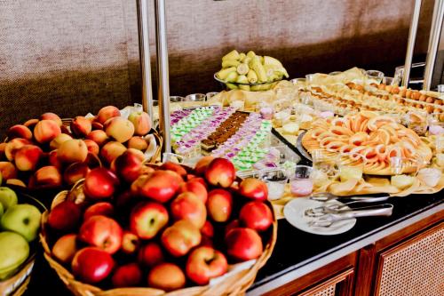 a buffet with apples and other food on a table at Royal Bay Hotel - All Inclusive in Elenite