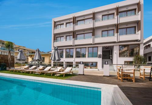 a hotel with a swimming pool in front of a building at Harma Boutique Hotel in Hersonissos