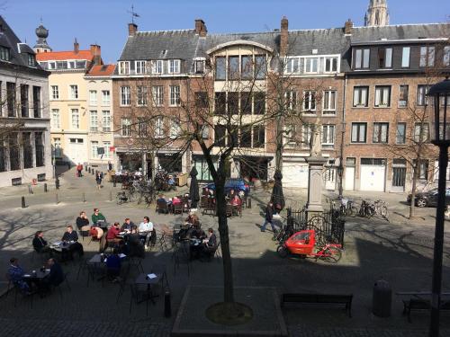 a group of people sitting in chairs in a courtyard at The View - spacious 2 bdr appt in with view in Antwerp