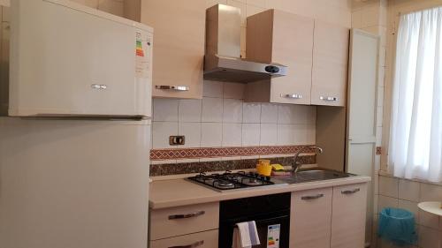 eine Küche mit einem Kühlschrank und einem Herd Top-Backofen in der Unterkunft Fornaro Apartments in Genua