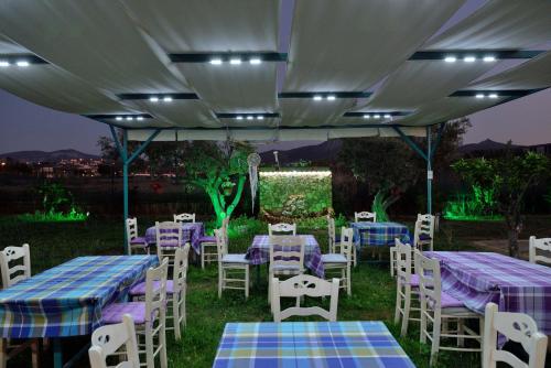 a group of tables and chairs under a tent at La Terra Nostra in Korinthos