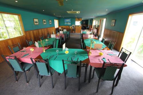 a dining room filled with tables and chairs at Tully Motel in Tully
