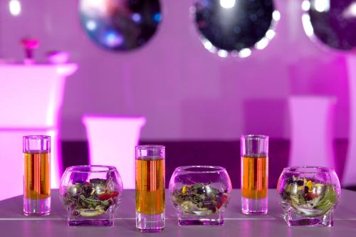 a group of four wine glasses with golditures in them at Barceló Sants in Barcelona