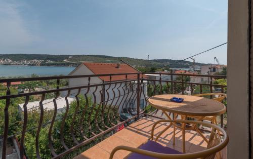 a balcony with a table and a view of the water at Villa Marija in Trogir
