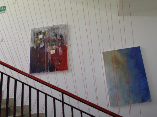 two pictures hanging on a wall next to a staircase at Dimora Hostel in Agrigento