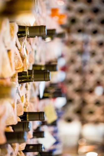 a bunch of wine bottles hanging on a rack at Tenuta Del Gallo in Amelia