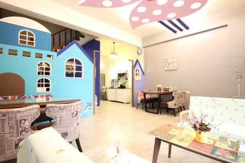 a living room with a house painted on the wall at Harbourview in Taitung City