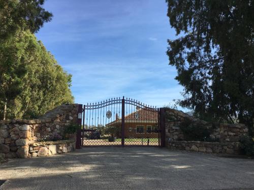 a gate in front of a house with a building at Villa Arzilla Sardegna in Alghero