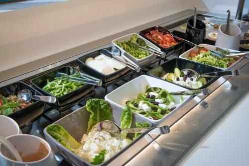 a buffet line with several trays of food at Harma Boutique Hotel in Hersonissos