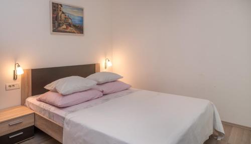 a bedroom with a bed with two pillows on it at Villa Marija in Trogir