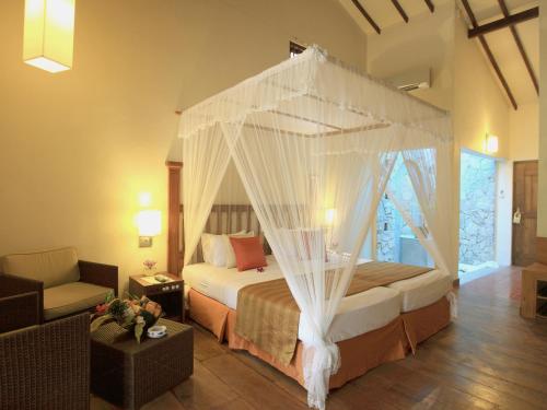 Ένα ή περισσότερα κρεβάτια σε δωμάτιο στο Siddhalepa Ayurveda Resort - All Meals, Ayurveda Treatment and Yoga