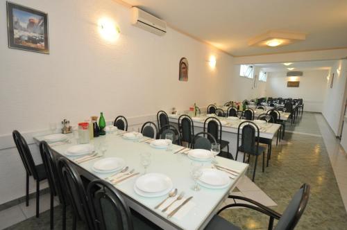 a group of tables and chairs in a room at Pansion Bojic in Međugorje