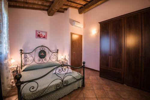 a bedroom with a bed and a wooden cabinet at Agriturismo Casetta I in Vinci