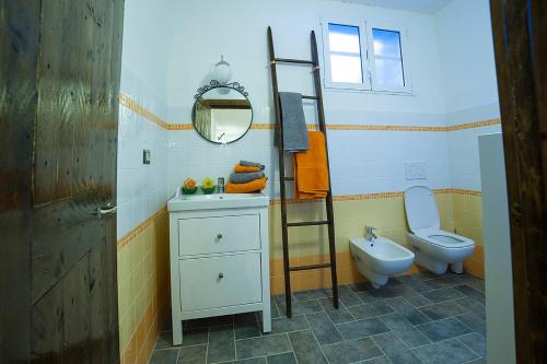 a bathroom with a sink and a toilet and a ladder at Cà di Gatti Apartment in Ne