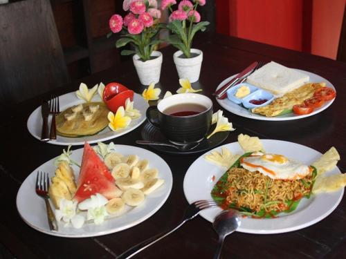 a table with four plates of food on it at D'Mell Bali in Nusa Dua