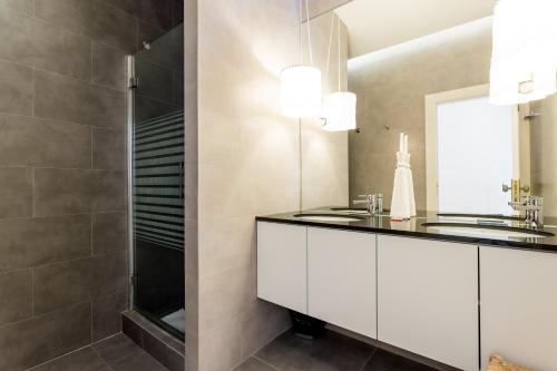 La salle de bains est pourvue d'un lavabo et d'une douche. dans l'établissement FLH Baixa Modern Apartment, à Lisbonne