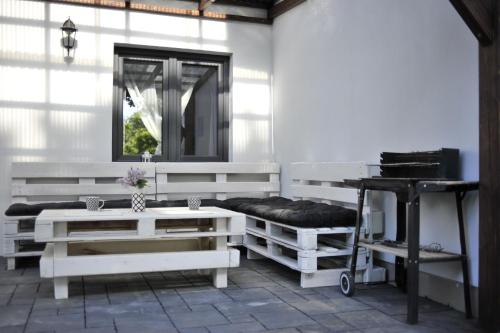 a bathroom with white benches and a mirror at przy lesie in Białowieża