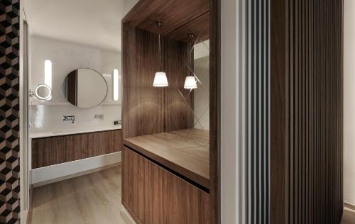a bathroom with a wooden vanity and a mirror at Evridiki in Kilkís