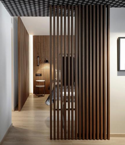 a living room with a wooden wall with a sliding door at Evridiki in Kilkís