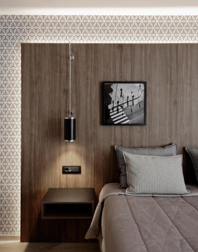 a bedroom with a bed with a nightstand next to it at Evridiki in Kilkís