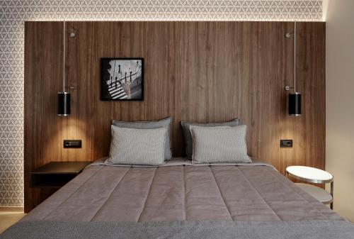 a bedroom with a large bed with wooden walls at Evridiki in Kilkís