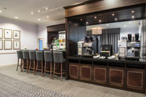 a bar with a counter with stools in a room at New Place in Fareham