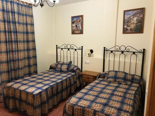 Ένα ή περισσότερα κρεβάτια σε δωμάτιο στο Apartamentos Arroyo Frío