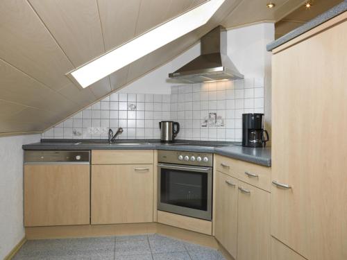 a kitchen with a sink and a stove top oven at Fewo Gabi in Neuschönau