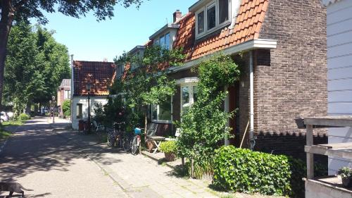 a house with a bike parked next to a street at Family House Amsterdam in Amsterdam