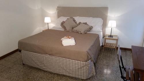 a bedroom with a bed with a purse on it at In Vacanza da Marinella in Albenga