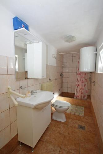 a bathroom with a white sink and a toilet at Marašić in Ždrelac