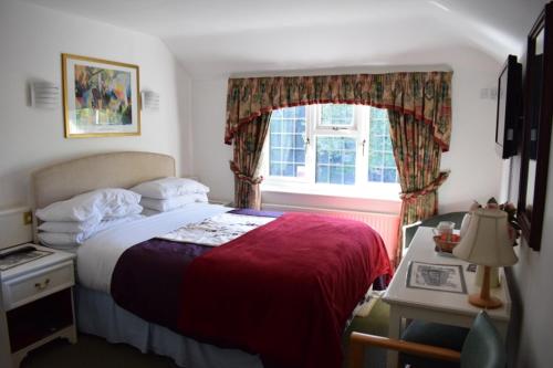 a bedroom with a large bed and a window at Clifton Bridge Hotel in York